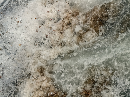 Photography Abstract texture of dirty foamed sea water on the beach