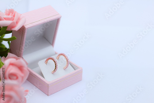 Pink sapphire earring in pink jewelry box on white background. Precious gift or present for special event