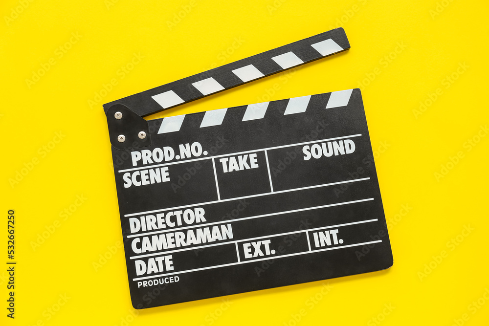 Movie clapper on yellow background