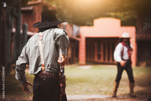 Backside view of cowboy while standing gun prepares on gunfight in cowboys village is cowboy western lifestyle concept Fototapet