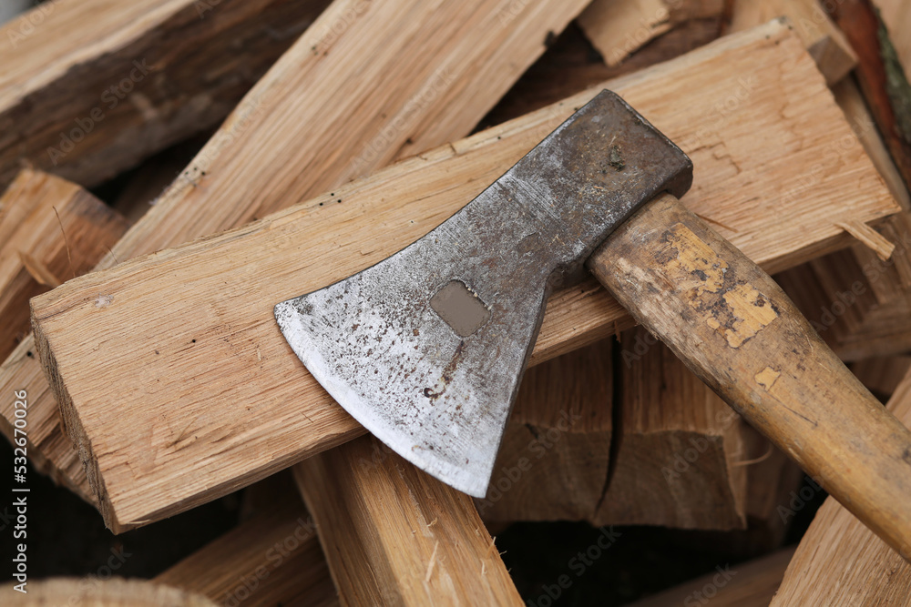 A sharp iron ax for cutting oak firewood.