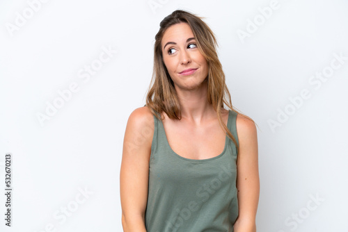 Young caucasian woman isolated on white background making doubts gesture looking side