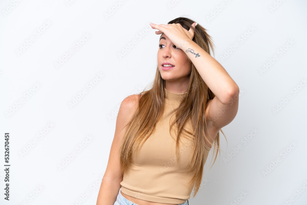 Fototapeta premium Young caucasian woman isolated on white background doing surprise gesture while looking to the side