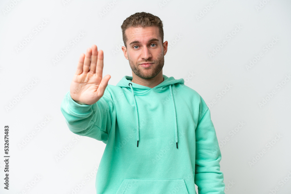 Young handsome caucasian man isolated on white background making stop gesture