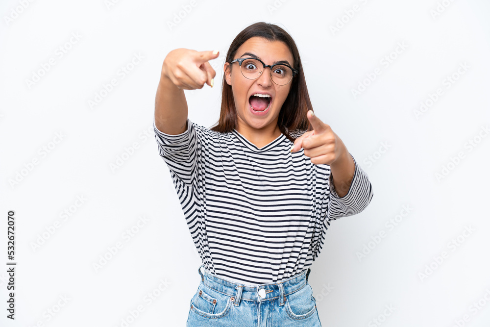 Fototapeta premium Young caucasian woman isolated on white background surprised and pointing front
