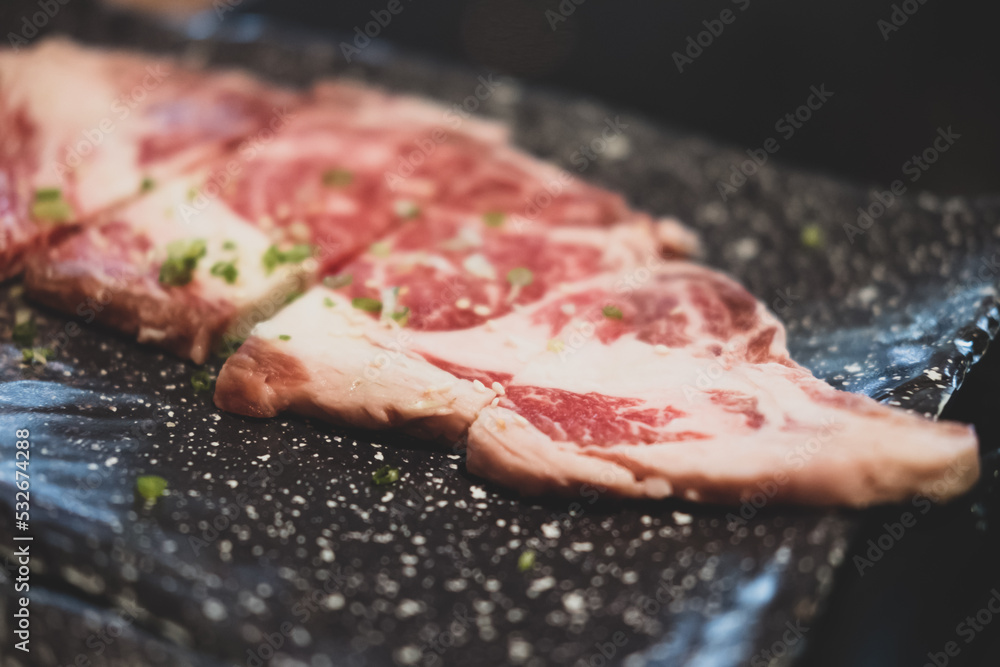 Premium rare sliced beef served for Yakiniku. Close up