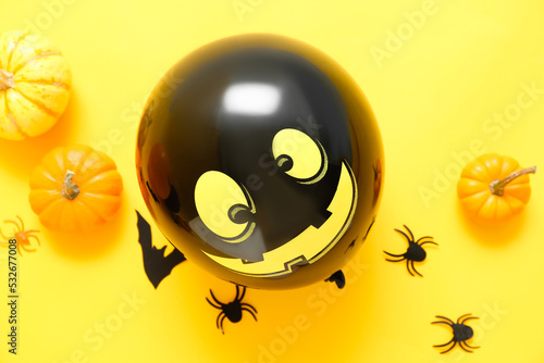 Composition with Halloween decor and pumpkins on yellow background