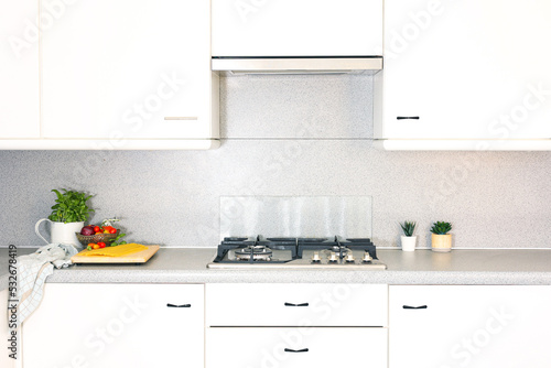 Home decor concept, clean kitchen in apartment decoration with white modern cabinet and counter. 