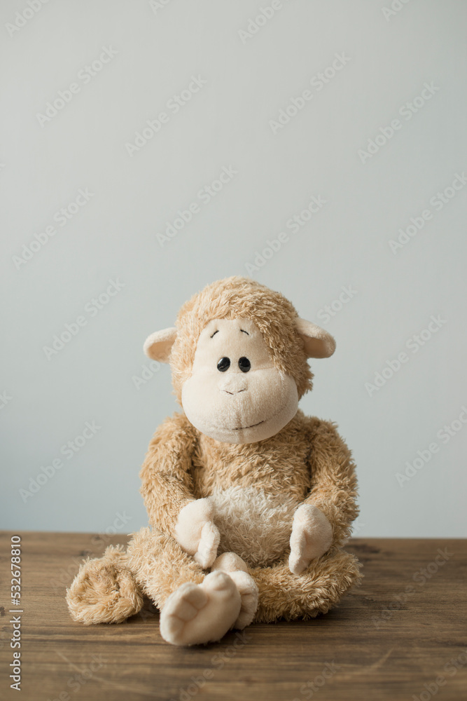 Fototapeta premium Soft children's toys monkey sitting on the table