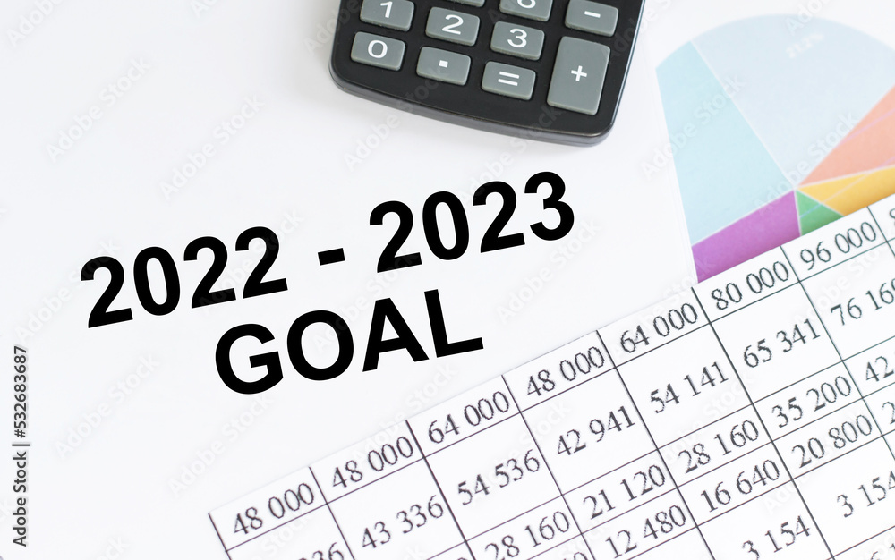 2022-2023 goal inscription on the notebook among the reports on the table next to the calculator 2022-2023 goal inscription on the notebook among the reports on the table next to the calculator
