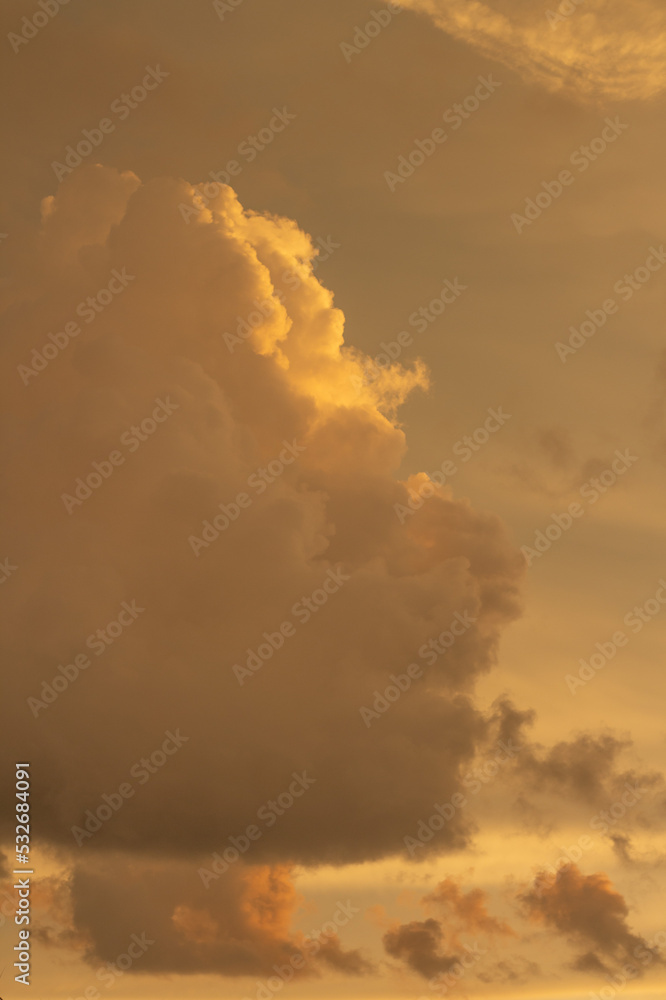 Orange clouds in the sky with sunlight before sunset