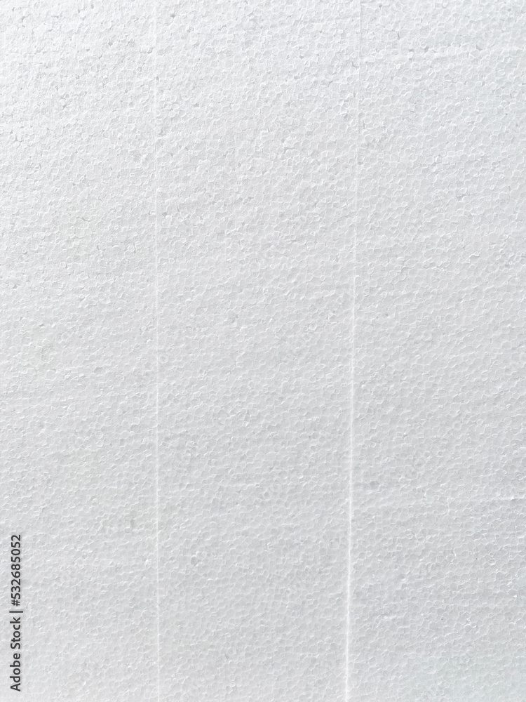 Fototapeta premium Close-up of the background of the white polystyrene foam structure with vertical stripes