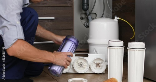 Plumber change the filter element in the water filter
