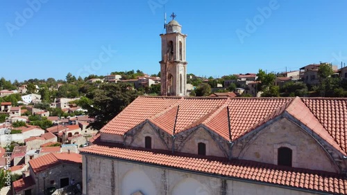 Aerial drone footage of traditional countryside village Lofou, Limassol, Cyprus. Close up of christian church Panayia Chrysolofitissa, ceramic tiled roof houses and cobbled narrow streets from above photo