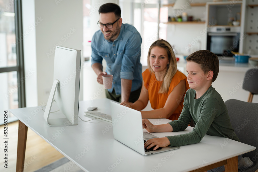 Working from home with child. Busy business parents working while kid playing on laptop. Working from home with child. Busy business parents working while kid playing on laptop.