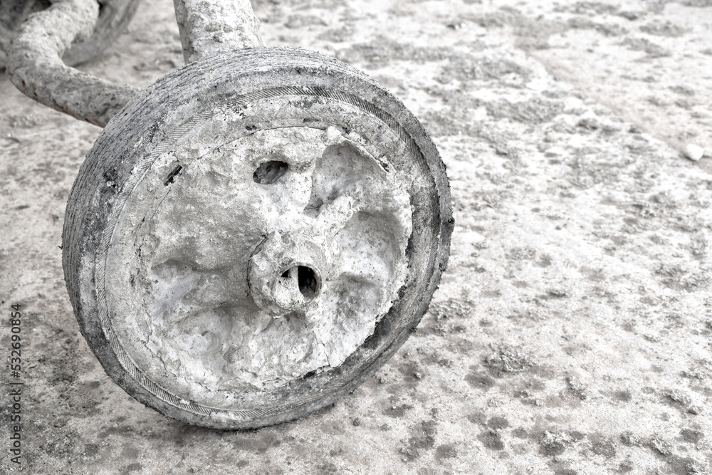 Wheelbarrow wheel be covered with harden dried concrete. Copy space is