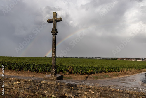 rainbow behind the romanee conti cross in vosne romanee photo