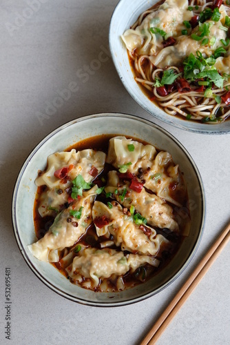 Homemade Chinese cuisine. Jiaozi Dumplings in Sichuan Gravy or Noodle. Tasty and savory with spicy and tongue numbing sensation. Dumplings wrapped with ground pork and shrimp and water chestnut
