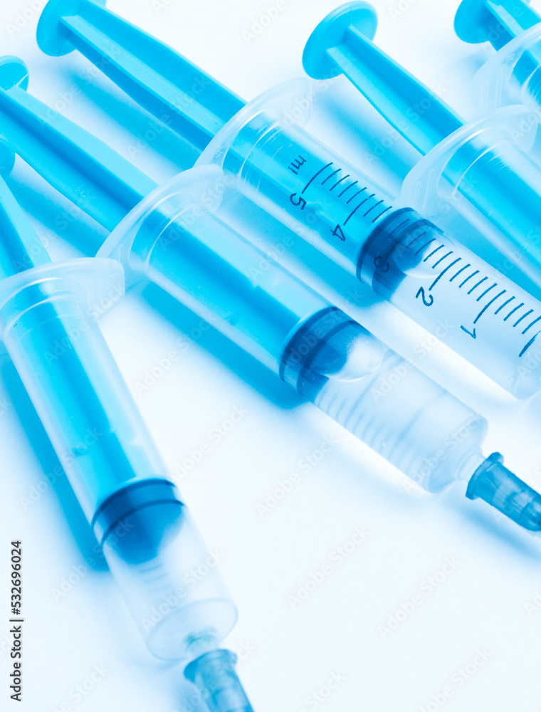 medical disposable syringe with needle for injection in the hospital. medical devices on a white background. virus protection concept medical disposable syringe with needle for injection in the hospital. medical devices on a white background. virus protection concept