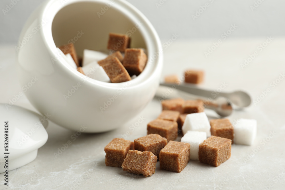 Bowl and refined sugar cubes on light table Bowl and refined sugar cubes on light table