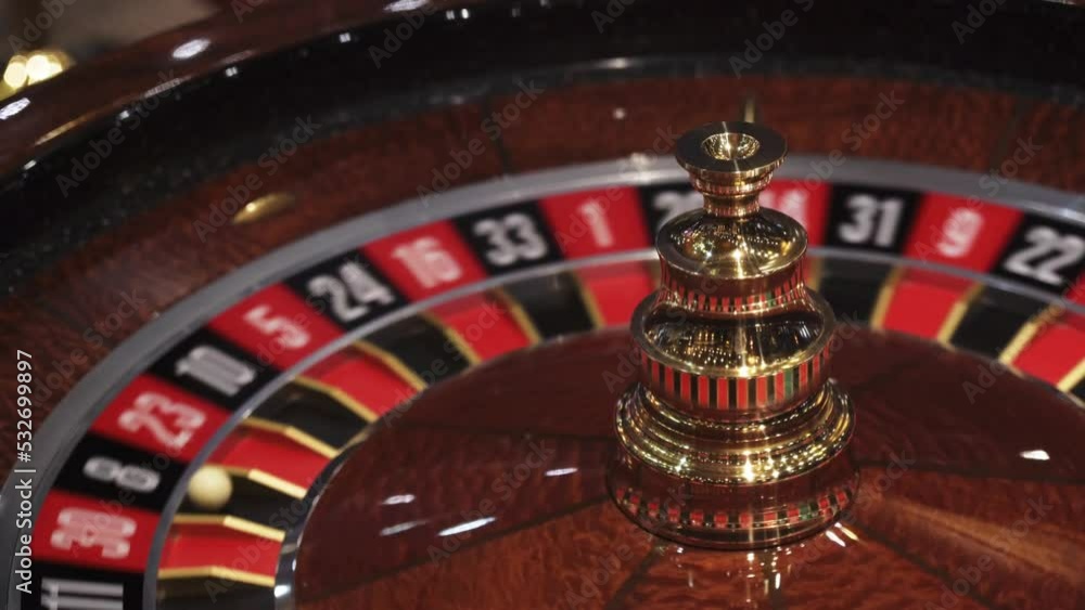 Spinning roulete ball bouncing on numbers in casino, closeup view of lucky number Spinning roulete ball bouncing on numbers in casino, closeup view of lucky number