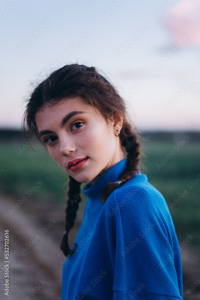 Close up brunette outdoor woman portrait in blue suit. Fashion, stylish photosession on sunset Close up brunette outdoor woman portrait in blue suit. Fashion, stylish photosession on sunset