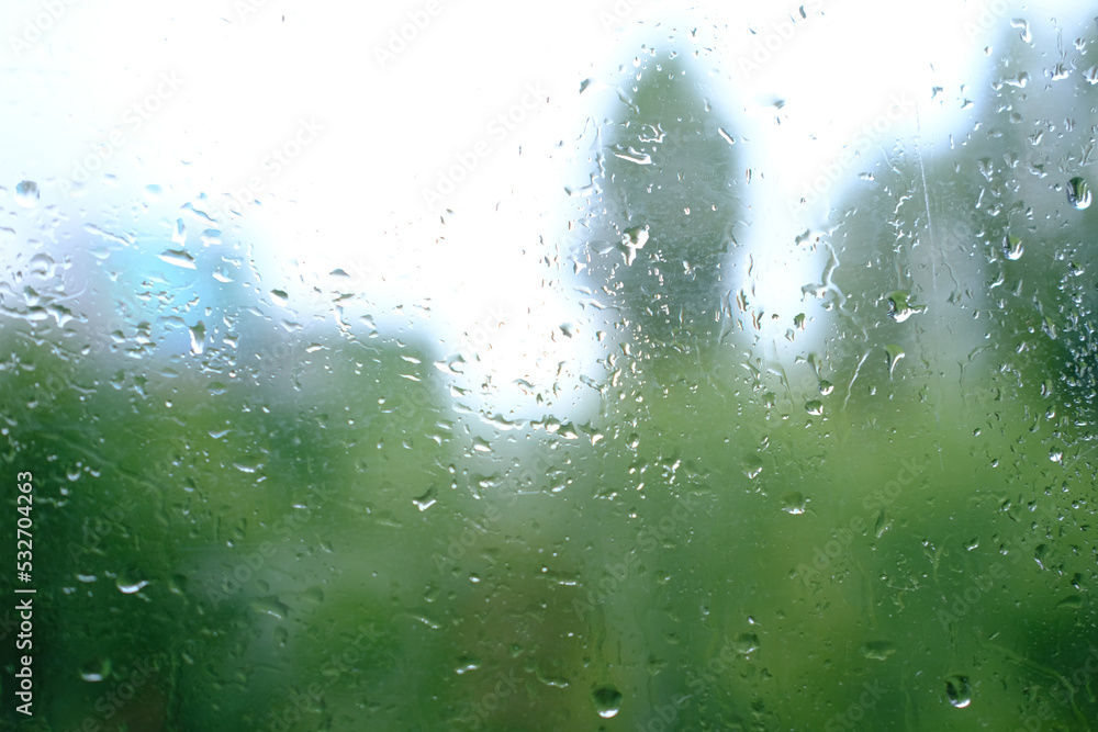 autumn rain outside window, orange foliage of trees out of focus, texture of glass background with water drops, place for text, horizontal banner with blurry bokeh, nature protection, Severe Weather autumn rain outside window, orange foliage of trees out of focus, texture of glass background with water drops, place for text, horizontal banner with blurry bokeh, nature protection, Severe Weather