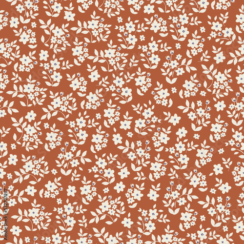 Vintage floral pattern with small white flowers and leaves on a terracotta background. Seamless pattern for design and fashion prints.Stock vector illustration.
