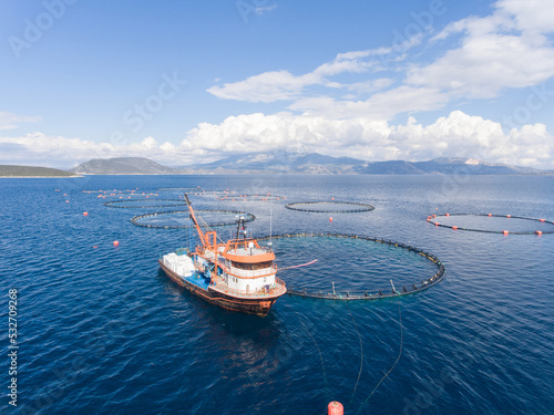 Photography Aerial view of fishing boat at fish farm