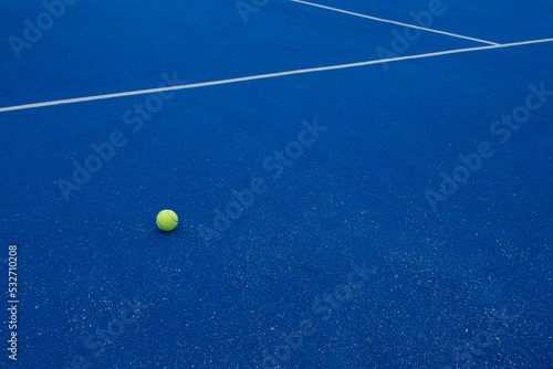 a ball on a blue paddle tennis court, racket sports © Vic
