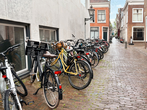 Many parked bicycles near building on city street © New Africa