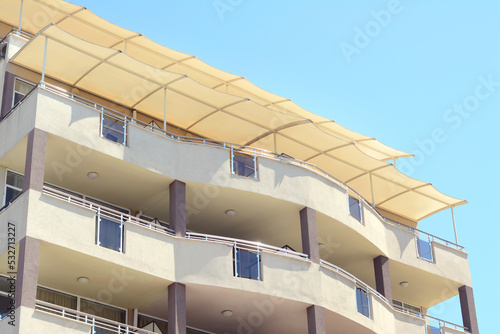 Obraz na plátně Exterior of beautiful residential building with balconies against blue sky