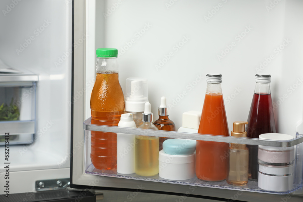 Different cosmetic products on shelf in refrigerator Different cosmetic products on shelf in refrigerator