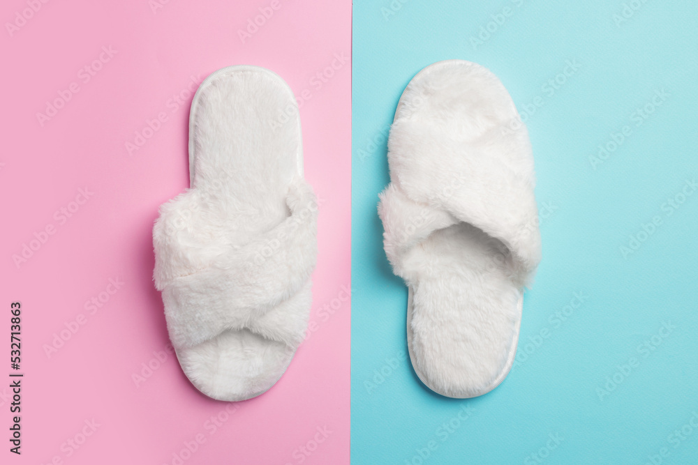 Pair of soft slippers on color background, top view Pair of soft slippers on color background, top view