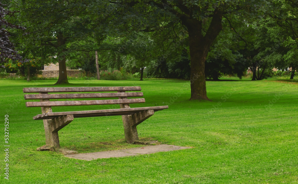 Wooden bench for relaxing in a green park Wooden bench for relaxing in a green park