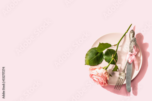 Romantic dinner table isolated on rose background. Love concept for Valentine's or Mother's day