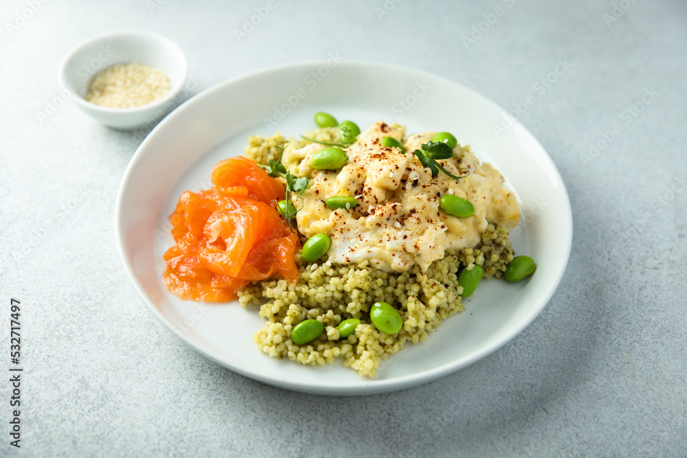 Scrambled eggs with couscous, salmon and beans