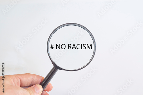 No to racism text in magnifying glass. awareness idea concept.
