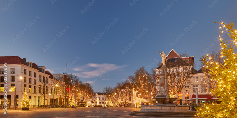 The central Brink square in the historic Dutch city Deventer in winter with christmas trees and decoration