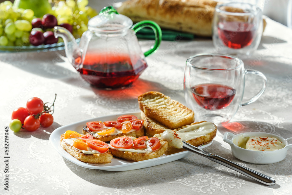 table full of breakfast food with bruschetta and hibiscus tea