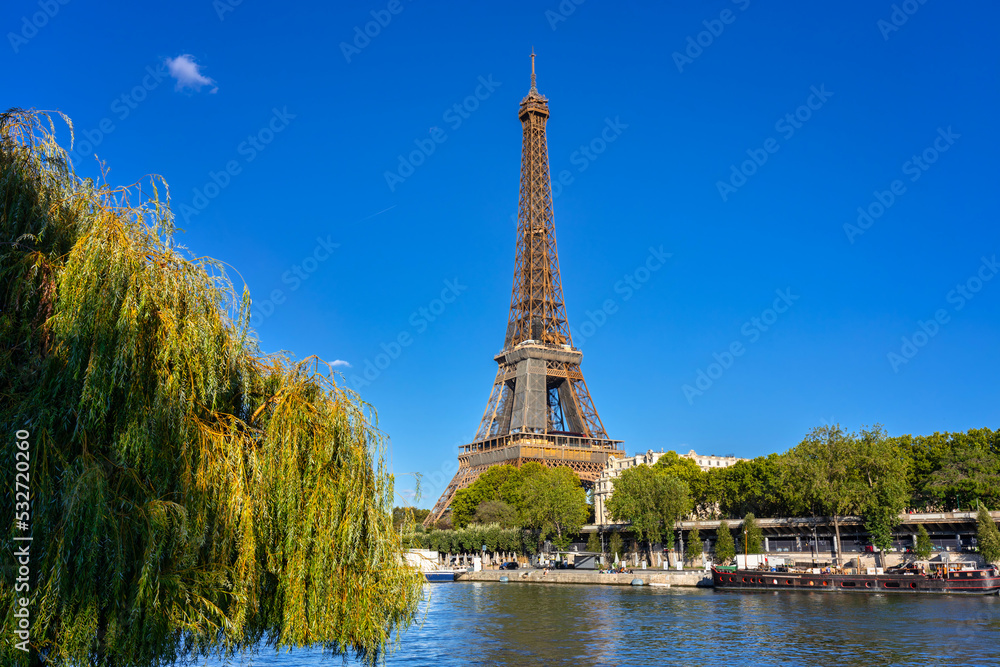 Fototapeta premium Eiffel Tower by the Seine River in Paris at summer. France