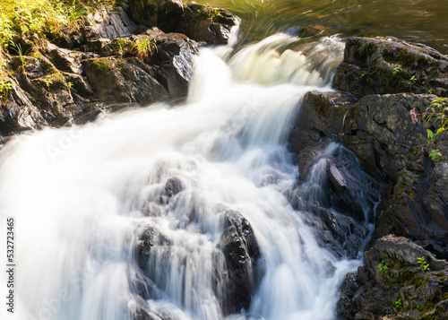 Fototapeta Naklejka Na Ścianę i Meble -  Maine waterfall running fast enough for motion blur