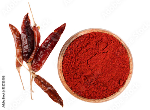 Top view of smoked red paprika in a wooden bowl and a few pepper pods on a white background. photo