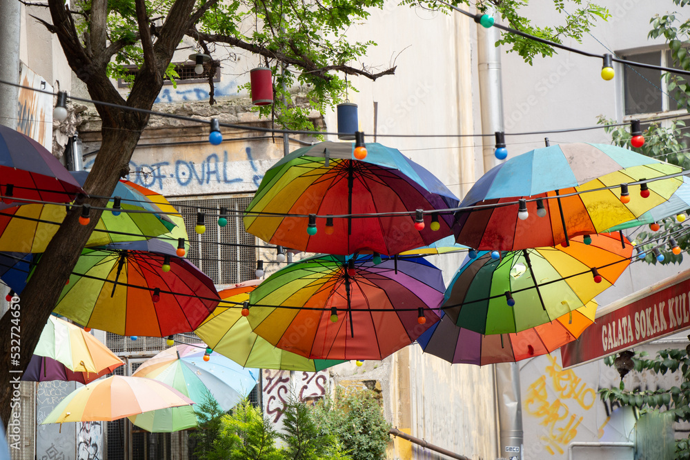 The street is decorated with many red color open umbrellas