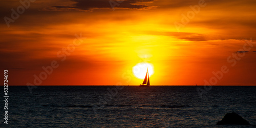 Panorama - Sunset over the sea with a sailing ship on the horizon