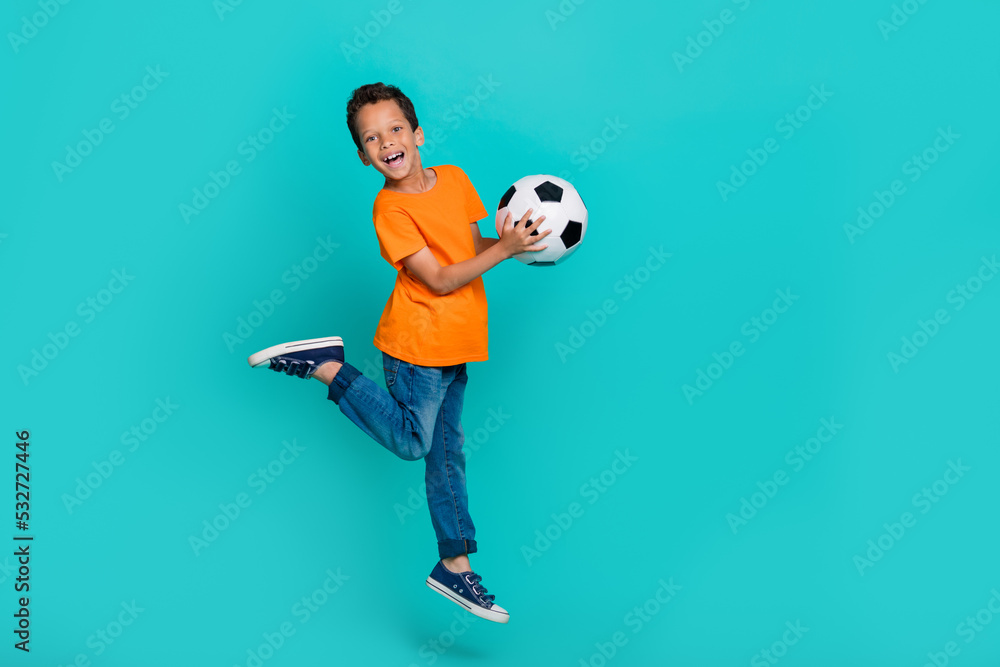 Full length photo of funny joyful glad boy football player fan winner champion goal hooray empty space isolated on cyan color background