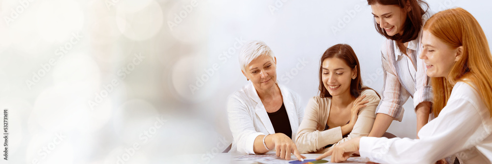 Web banner A group of young businessmen Talking and planning work happily and have fun. at the company's office with copy space on left Web banner A group of young businessmen Talking and planning work happily and have fun. at the company's office with copy space on left