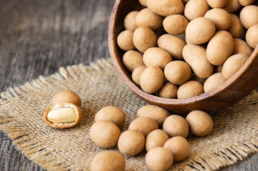 Soy-covered Peanuts with sauce in wooden bowl, traditional turkish coated nut Soy-covered Peanuts with sauce in wooden bowl, traditional turkish coated nut