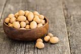 Soy-covered Peanuts with sauce in wooden bowl, traditional turkish coated nut 