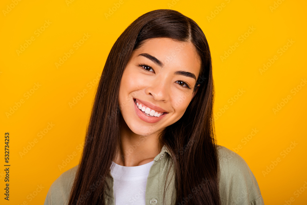 Photo of gorgeous glad person toothy beaming smile look camera isolated on vivid yellow color background Photo of gorgeous glad person toothy beaming smile look camera isolated on vivid yellow color background